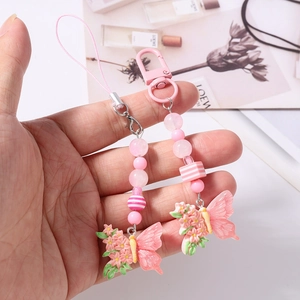 Pink beaded phone charm set with resin butterfly pendant and metal lobster clasp