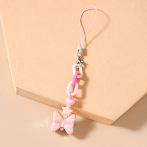 Detailed view of pink beaded phone charm with plastic links and a peach polka dot bow