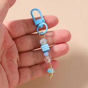 Close-up of sky blue beaded keychain with striped square beads and umbrella charm