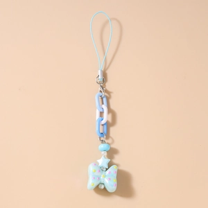Close-up of beaded phone strap with blue bow pendant and star charms on beige background