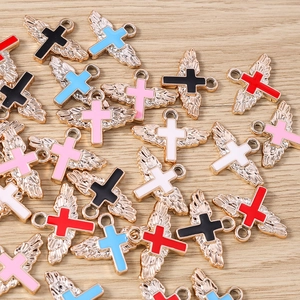 Macro detail of colorful angel wing cross charms for DIY jewelry making and crafts