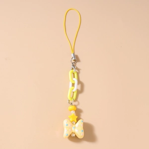 Detail of candy-colored phone strap with yellow star beads and a polka dot ribbon charm