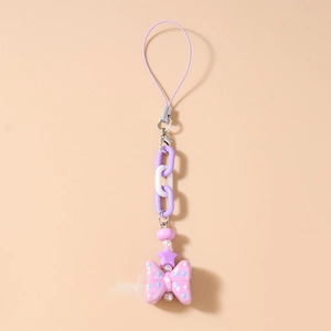 Detail of purple beaded phone strap with plastic chain links and large polka dot bow charm