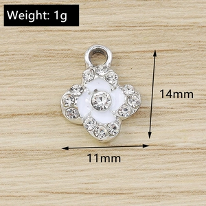 Detailed close-up of a silver four-leaf clover pendant with white enamel and zircons