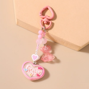 Detailed close-up of pink bear keychain with Forever Love heart charm and beads