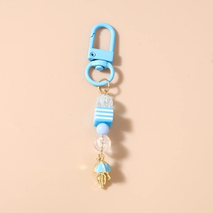 Detail of blue jellyfish keychain with striped beads and a gold jellyfish charm