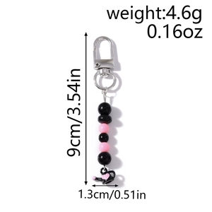 Détail de la dragonne de téléphone perlée avec théière cœur, taille 9cm et poids de 4,6g