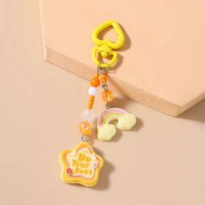 Close-up of heart clasp and rainbow star keychain with Be Your Best quote and colorful beads