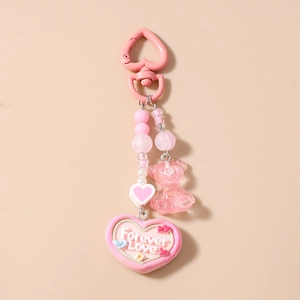 Close-up of pink beaded keychain with a resin bear and heart pendant with Forever Love text