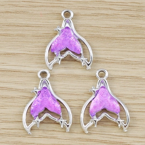 Three purple glitter fish tail pendants with silver star accents for DIY jewelry making