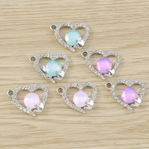 Detailed view of heart-shaped pendants with colorful rhinestones for DIY jewelry making