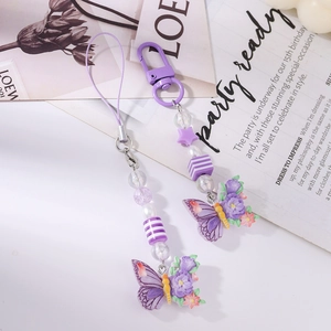 Detail of purple butterfly phone charms and keychains with beaded stars and flowers