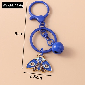 Blue butterfly moth enamel keychain detail with size and weight measurements on background