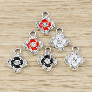 Macro shot of three-color clover pendants with enamel inlay and rhinestone edges