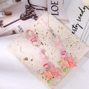 Detailed view of pink beaded phone straps featuring 3D butterfly and flower resin charms