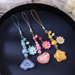 Three colorful beaded phone charms with daisy flower charms and star heart cloud pendants