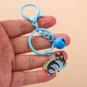 Cartoon blue cat enamel keychain with bell and lobster clasp on light background