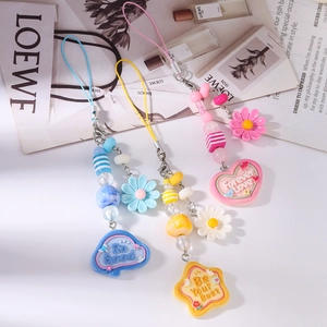 Detail of beaded daisy phone straps with resin hearts, stars and clouds charms