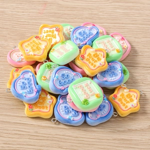 Detailed view of colorful resin heart and star charms with embossed English motivational text