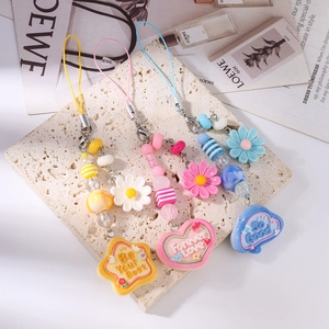 Three beaded floral phone charms with colorful stars hearts and positive resin charms