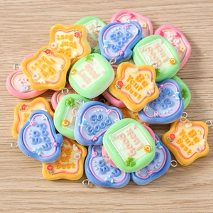 Macro shot of colorful resin DIY charms with heart shapes and inspirational phrases
