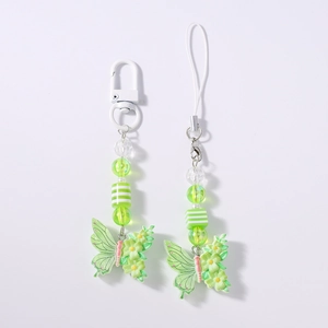 Detail of light green butterfly charm with yellow floral patterns on a beaded phone strap