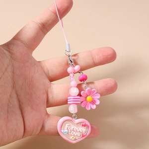 Detail of pink beaded phone charm with daisy accents and a Forever Love heart pendant