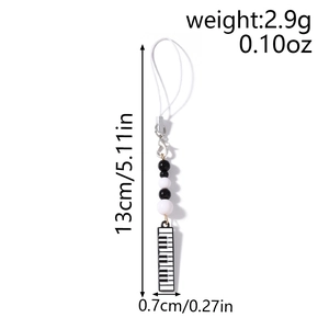 Detail view of 13cm black and white piano bead phone strap with measurement annotations