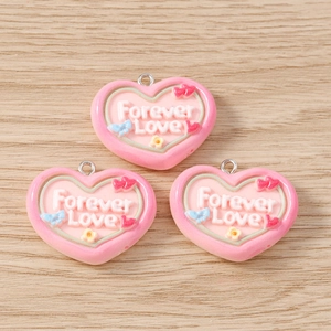 Detail of pink resin heart charms with Forever Love engraving and floral accents