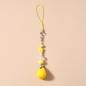 Detailed macro view of yellow beaded phone strap featuring a cute resin pear pendant and stars