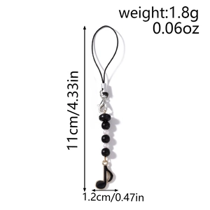 Detail view of black and white beaded phone strap with musical note charm and measurements