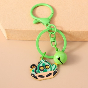 Close-up of green cartoon cat cactus keychain with metal clasp and matching bell