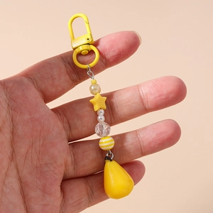 Detail of yellow star beaded phone charm featuring lemon-colored pearls and star pendant