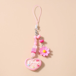 Detailed macro view of pink heart-shaped charm with Forever Love engraving and beads