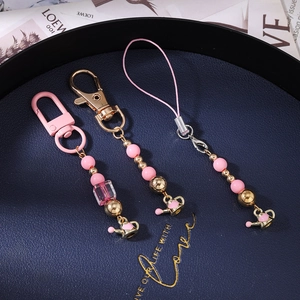 Pink beaded phone charm strap with gold watering can pendant and resin beads set