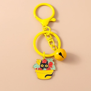 Detail of cartoon cat in strawberry pot keychain with yellow bell and lobster clasp
