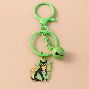 Close-up of a green cartoon cat keychain with lobster clasp and a small bell