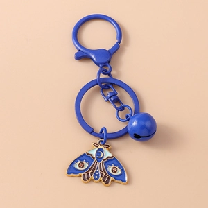 Detailed macro shot of blue enamel moth pendant with moon and stars golden engraving