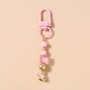 Detailed pink beaded phone strap featuring a gold watering can charm with heart detail