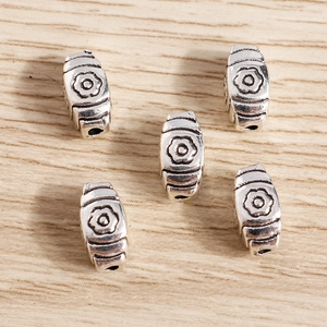 Vintage silver flower spacer beads for DIY jewelry making set of five on wood