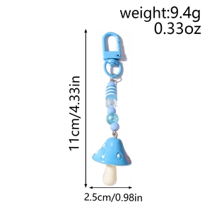 Detailed view of blue mushroom keychain with dimensions and weight measurements shown