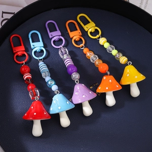 Set of five colorful mushroom beaded keychains with striped beads and resin charms