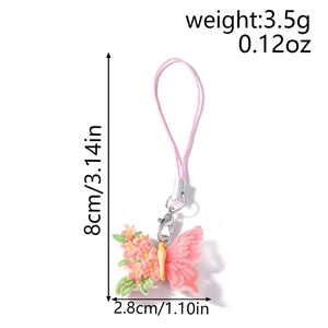 Pink butterfly and flower phone charm accessory with dimensions 8cm by 2.8cm