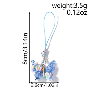 Detail view of sky blue butterfly phone charm with floral patterns and dimension labels