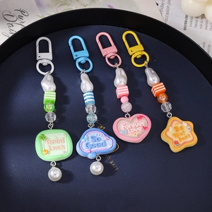 Set of 4 colorful beaded keychains with pearls and geometric pendants in various shapes