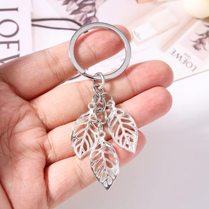 Minimalist silver clover leaf keychain with hollow texture for handbag accessories