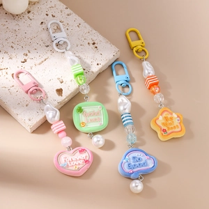 Chic macaron-colored keychain set featuring resin charms, pearls, and heart-shaped pendants