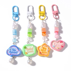 Colorful striped pearl keychains with heart and star charms in four candy colors