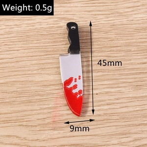 Macro shot of horror-themed bloody cleaver charm showing dimensions 45mm by 9mm