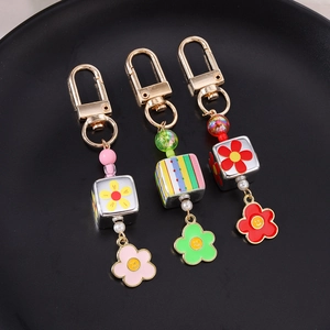 Portachiavi con perline margherita e ciondoli a forma di fiore sorridente in rosa e verde
